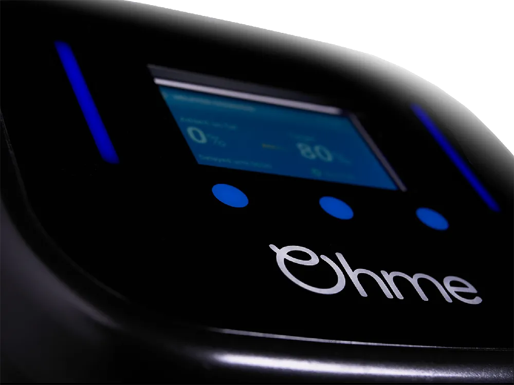 Close-up of the Ohme Home Pro tethered EV charger, showing LCD screen and illuminated control buttons.